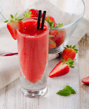 Strawberry smoothie with fresh berries on a wooden table . Selective focusの写真素材