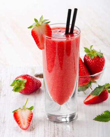 Strawberry smoothie with fresh berries on a wooden table . Selective focusの写真素材