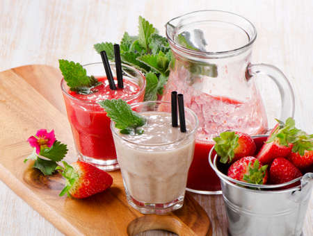 Strawberry smoothie with fresh berries on a wooden table . Selective focusの写真素材
