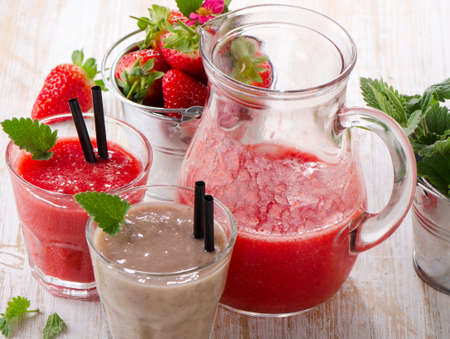 Strawberry smoothie with fresh berries on a wooden table . Selective focusの写真素材