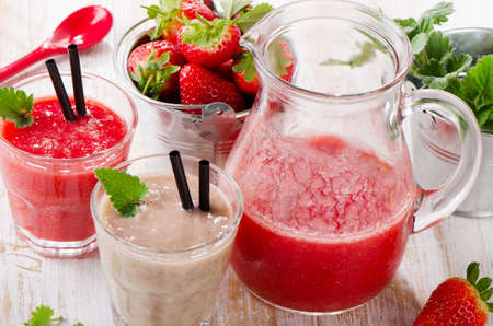 Strawberry smoothie with fresh berries on a wooden table . Selective focusの写真素材