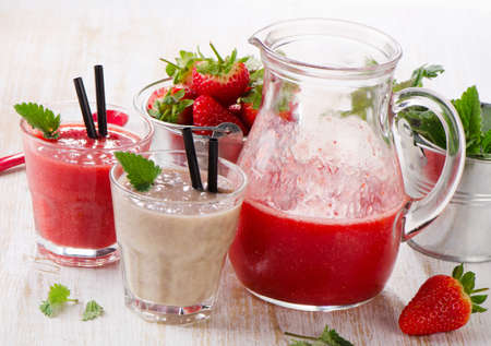 Strawberry smoothie with fresh berries on a wooden table . Selective focusの写真素材