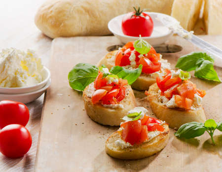 Bruschetta  with fresh tomatoes, cheese and basil. Selective focusの写真素材