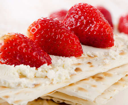 matzoh With cheese and berries  on a wooden table. Selective focusの写真素材
