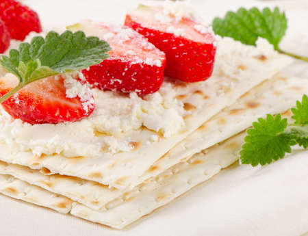 matzoh With cheese and berries  on a wooden table. Selective focusの写真素材