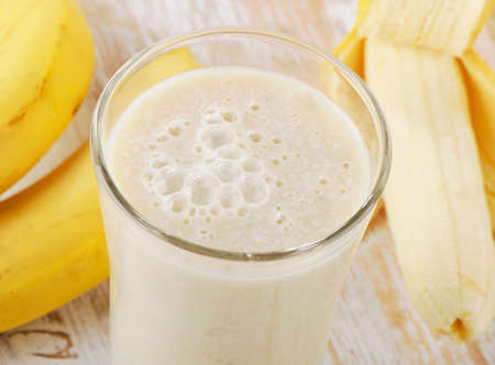 Banana Smoothie on a wooden table. Selective focusの写真素材