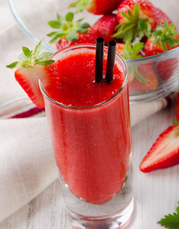 Strawberry smoothie with fresh berries on a wooden table . Selective focusの写真素材