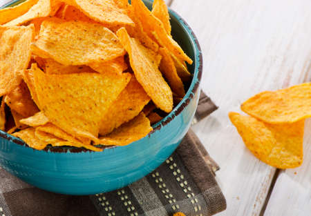 Corn chips on a wooden table. Selective focusの写真素材