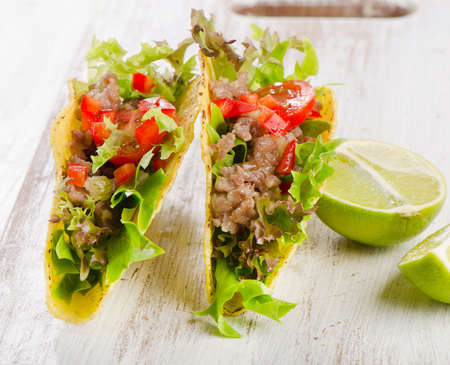 Mexican tacos on a wooden table. Selective focusの写真素材