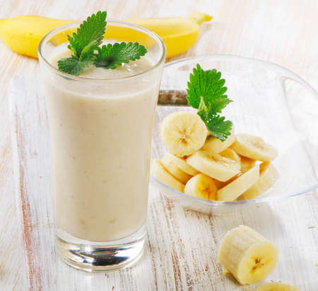 Banana Smoothie on a wooden table. Selective focusの写真素材