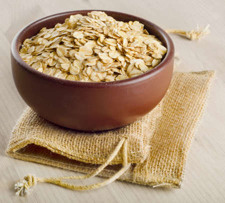 Oat flakes on a wooden table. Selective focus の写真素材