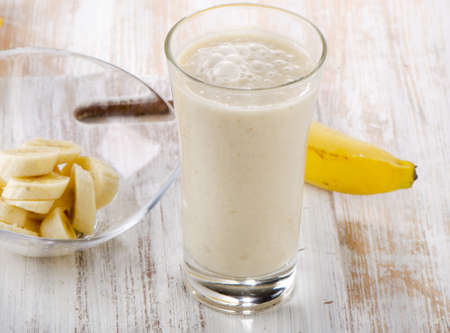 Banana Smoothie on a wooden table. Selective focusの写真素材