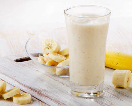Banana Smoothie on a wooden table. Selective focusの写真素材