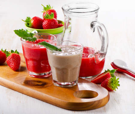 Strawberry smoothie with fresh berries on a wooden table . Selective focusの写真素材