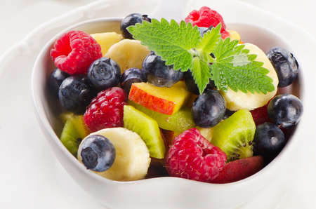 Fresh healthy fruit salad with mint leaves. Selective focusの写真素材