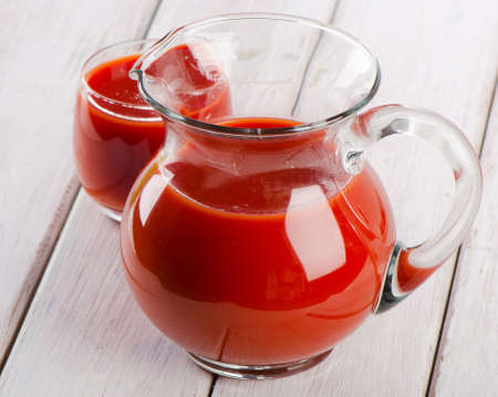 Tomato juice on a wooden tableの写真素材