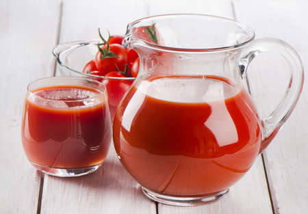 Tomato juice on a wooden tableの写真素材