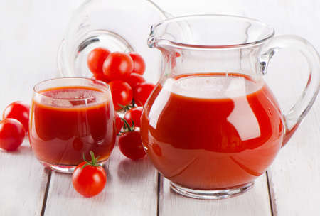 Tomato juice on a wooden tableの写真素材