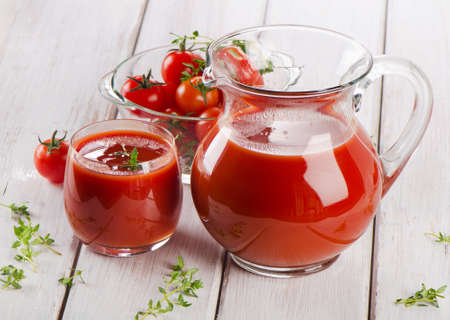 Tomato juice with fresh herbsの写真素材