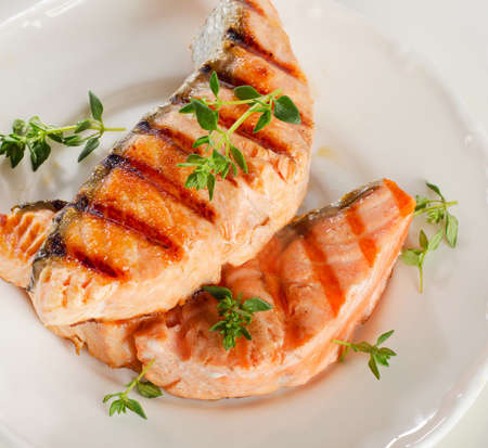 Grilled salmon with fresh herbsの写真素材