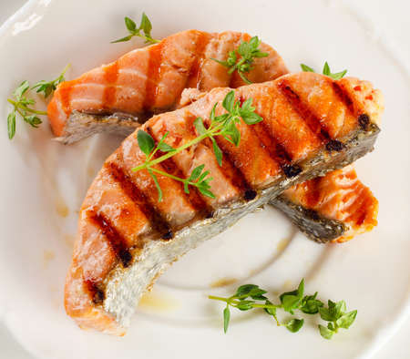 Grilled salmon with fresh herbsの写真素材