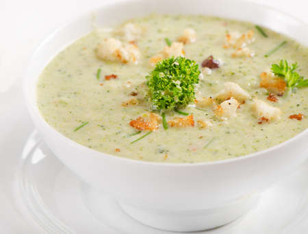 Delicious creamy vegetable soup with fresh herbsの写真素材
