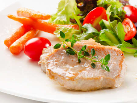 Roast pork with fresh vegetablesの写真素材
