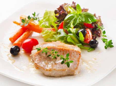 Roasted pork with fresh vegetablesの写真素材