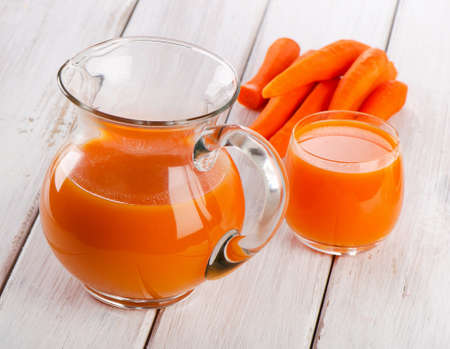 Carrot juice in a glass jugの写真素材