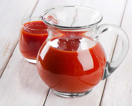 Tomato juice on a wooden tableの写真素材