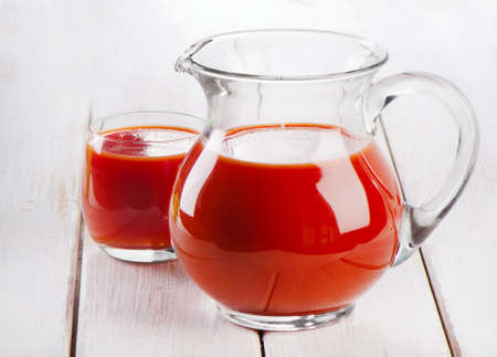 Tomato juice on a wooden tableの写真素材