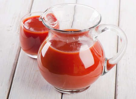 Tomato juice on a wooden tableの写真素材