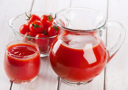 Tomato juice on a wooden tableの写真素材