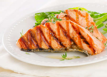 Grilled salmon with fresh herbsの写真素材