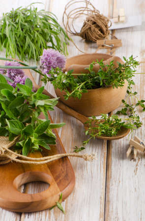 Various fresh herbs on a wooden tableの写真素材