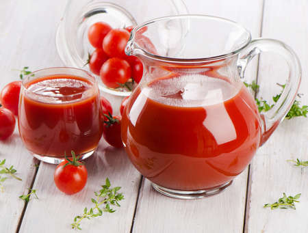 Tomato juice with fresh herbsの写真素材