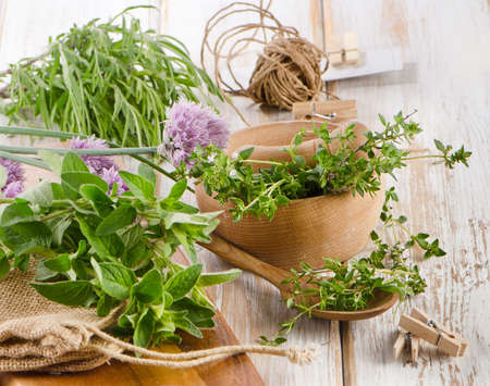 Various fresh herbs on a wooden table . Selective focusの写真素材