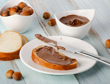 Bread and Chocolate cream on wooden table. Selective focusの写真素材