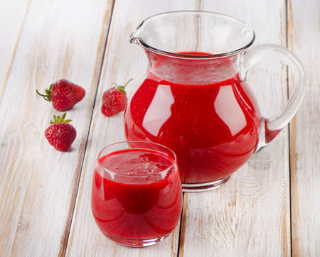 Strawberry smoothie with fresh berries on a wooden table . Selective focusの写真素材