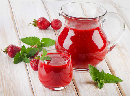 Strawberry smoothie with fresh berries on a wooden table . Selective focusの写真素材