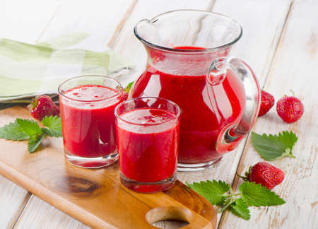 Strawberry smoothie with fresh berries on a wooden table . Selective focusの写真素材