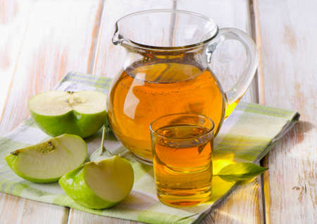Apple juice and apples on wooden table. Selective focusの写真素材