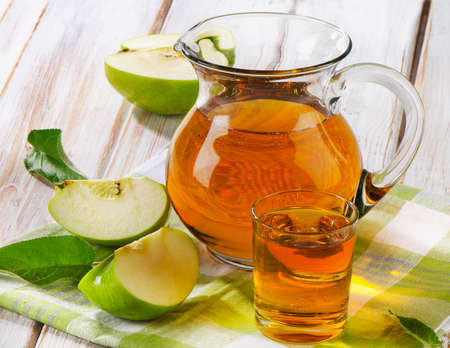Apple juice and apples on wooden table. Selective focusの写真素材