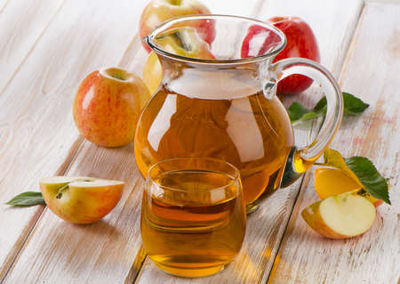 Apple juice and apples on wooden table. Selective focusの写真素材