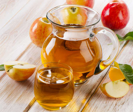 Apple juice and apples on wooden table. Selective focusの写真素材