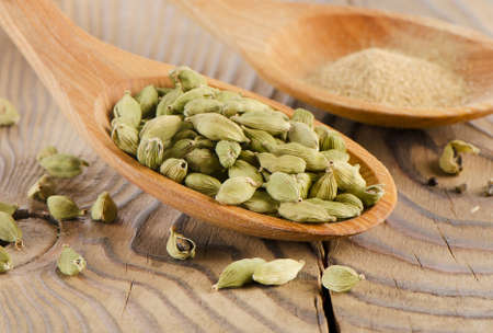 Cardamon in a wooden spoon . Selective focusの写真素材