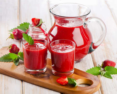 Strawberry smoothie with fresh berries on a wooden table . Selective focusの写真素材