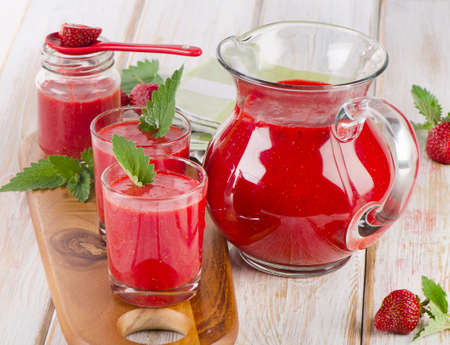 Strawberry smoothie with fresh berries on a wooden table . Selective focusの写真素材