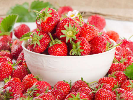 Fresh strawberries on a wooden table. Selective focusの写真素材