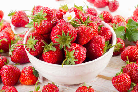 Fresh strawberries on a wooden table. Selective focusの写真素材